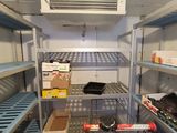a shopping cart in the middle of a room filled with shelves