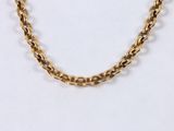 a close up of a gold chain necklace on a white background