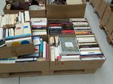 many boxes of books stacked on top of each other