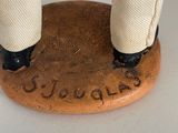 a figurine of a man standing on top of a coin