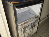 an image of a small refrigerator in the corner of a room
