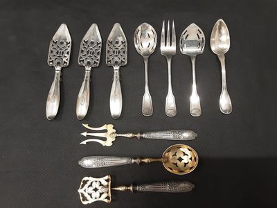 a lot of silver spoons and spoons on a table
