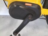 a close up of a yellow bicycle with a black seat