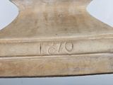 a statue of a man sitting on top of a table