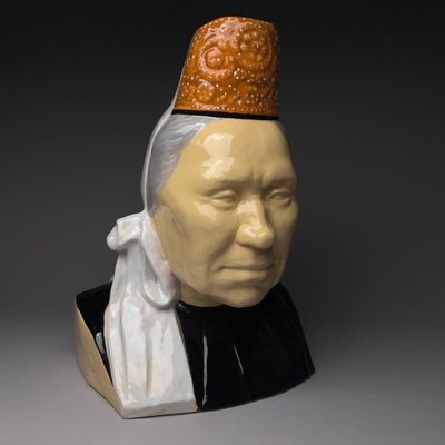 a close up of a statue of a person wearing a hat