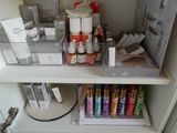 a shelf with a lot of bottles and containers on it