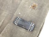 a close up of a piece of cloth with a cell phone in it