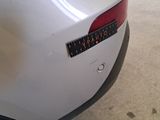 a close up of a white car with a speedometer on it