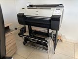 a large printer sitting on a stand in a room