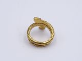 a close up of a gold ring on a white surface