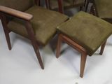 four chairs and a table in the middle of a room