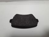 a small black object on a white surface with a white background