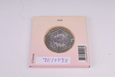 a close up of a pink box with a coin on top of it