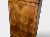 a wooden cabinet with jars on top of it