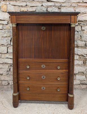 an image of a wooden cabinet with a marble top on a stone floor