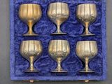 six silver goblets in a blue velvet case