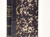 a black and gold book on a white surface