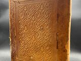 an old book sitting on top of a table next to a gray background