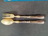 two forks and spoons are sitting next to each other on a table