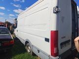 a man sitting on the ground next to a white van