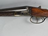 a close up of a gun on a table with a white background