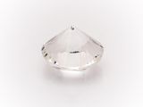 a close up of a clear crystal stone on a white surface
