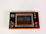 a small orange game console sitting on a white surface