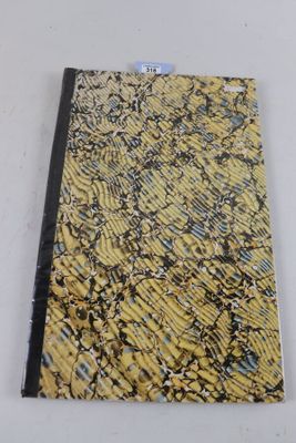 un gros plan d'un cahier jaune et noir posé sur une surface blanche