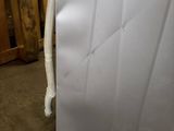 an image of a white refrigerator in a room