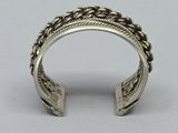 a close up of a silver ring on a gray surface