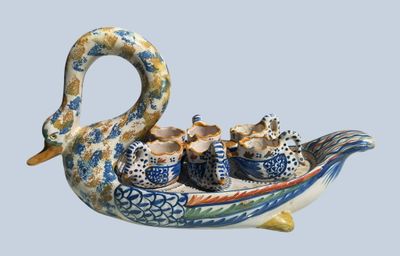a picture of a swan shaped dish with tea cups in it