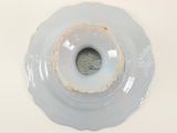a white plate with a hole in the middle of it