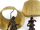 a lamp and a figurine on a white surface