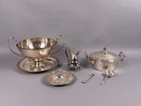 several pieces of silverware including a bowl, saucer, and spoon