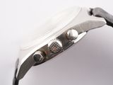a close up of a watch on a white surface