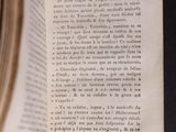 someone is holding a book open to a page with a picture of a clock on it