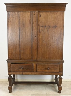 an old wooden cabinet with two drawers on it