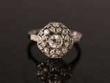 an antique diamond ring on a black surface