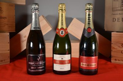 three bottles of wine sitting on a table next to wooden crates