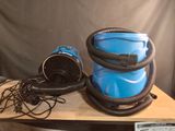 a blue blow dryer sitting on top of a wooden table