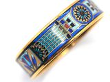 an image of a blue and gold bracelet with a clock tower on it