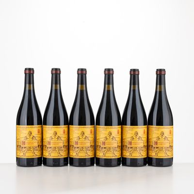 six bottles of wine are lined up on a table