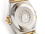 a close up of a watch on a white surface