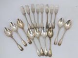 a lot of silver spoons and forks on the table