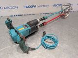 a close up of a drill on a table with a cord