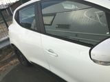 a small white car parked on the side of the road