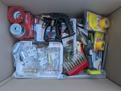 une boîte en carton remplie d'objets divers et une paire de ciseaux