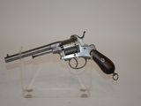 an old revolver with a wooden handle on a clear stand