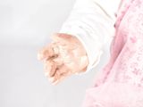 a close up of a person ' s hand holding something in the air