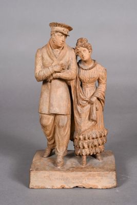 statue of a man and a woman standing on a stone base